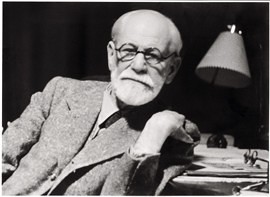 A black and white photo of a man with glasses and a beard.